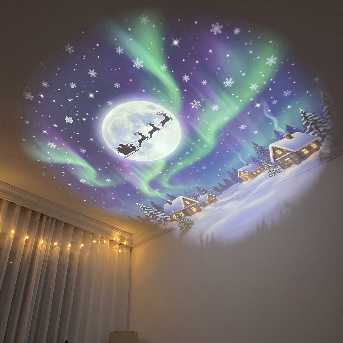Christmas ceiling projection showing Santa's sleigh, moon, snowflakes, winter village and aurora-inspired light