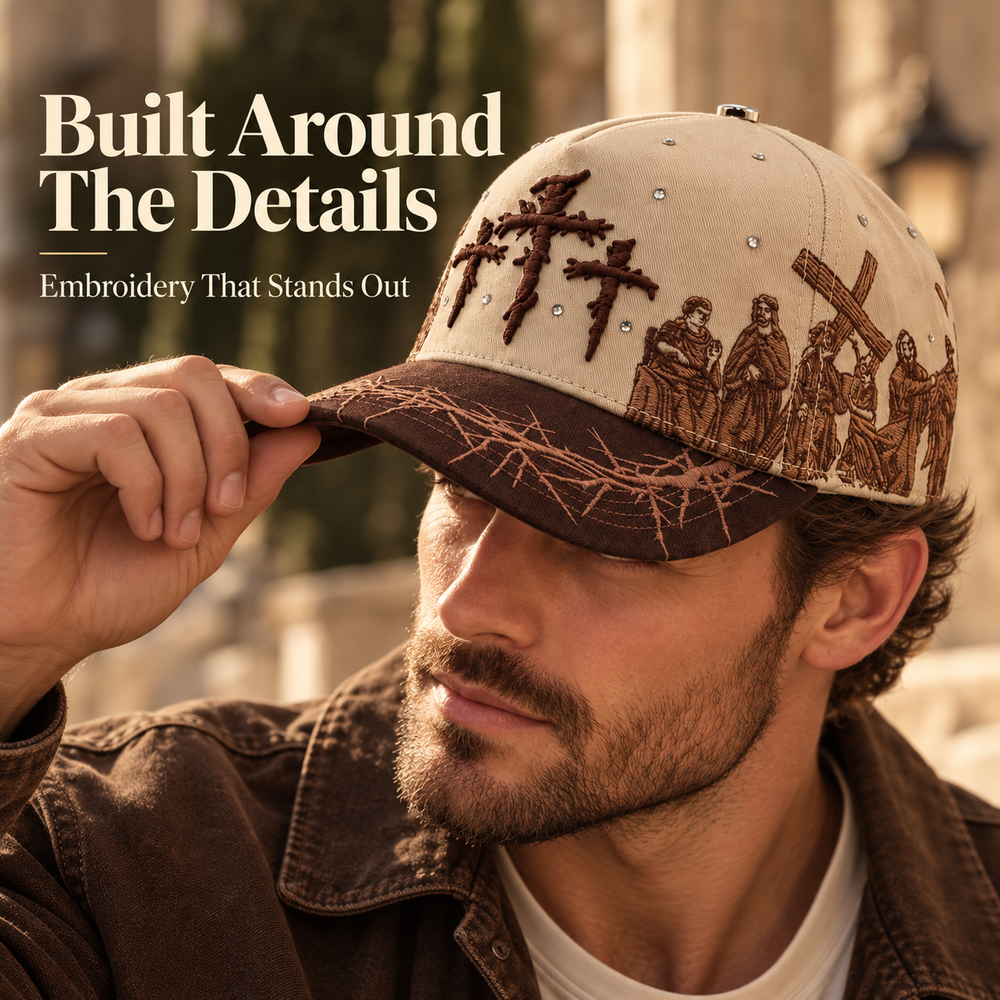 ViaCrucis brown cap worn with casual jacket emphasizing detailed Christian artwork